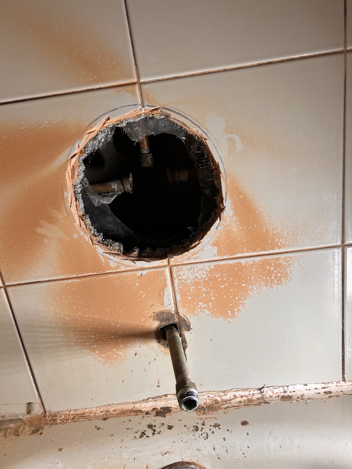 Controlled wall opening providing access to concealed shower valve piping